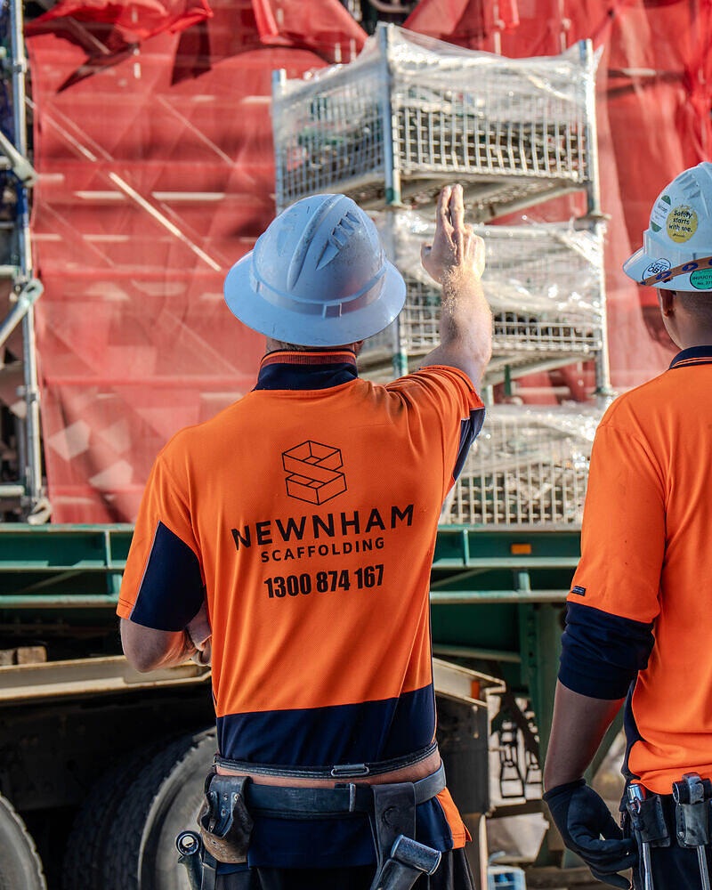 Newnham Scaffolding crew unloading scaffold at a Palm Beach project, photographed for marketing
