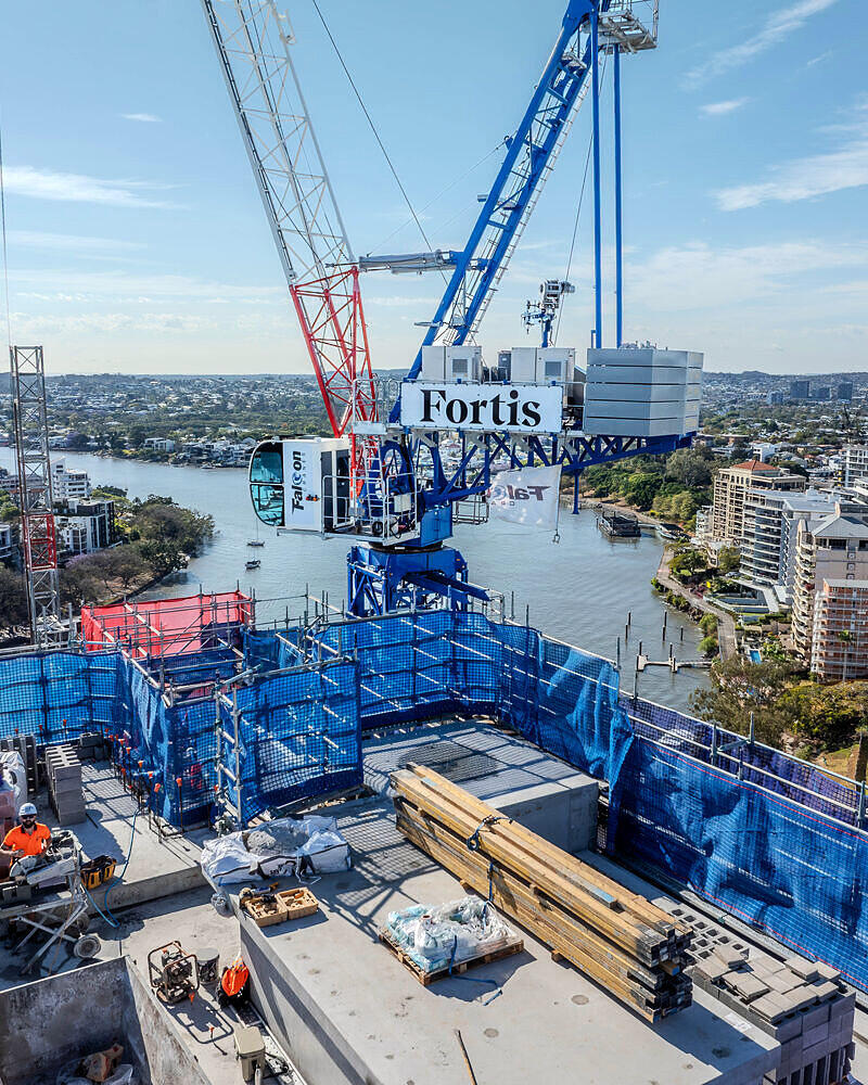 Tower crane above a Kangaroo Point high-rise and the Brisbane River, drone photo for Newnham Scaffolding